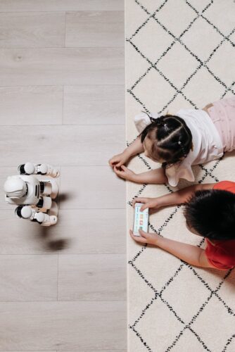 Two children playing with robot- computer science