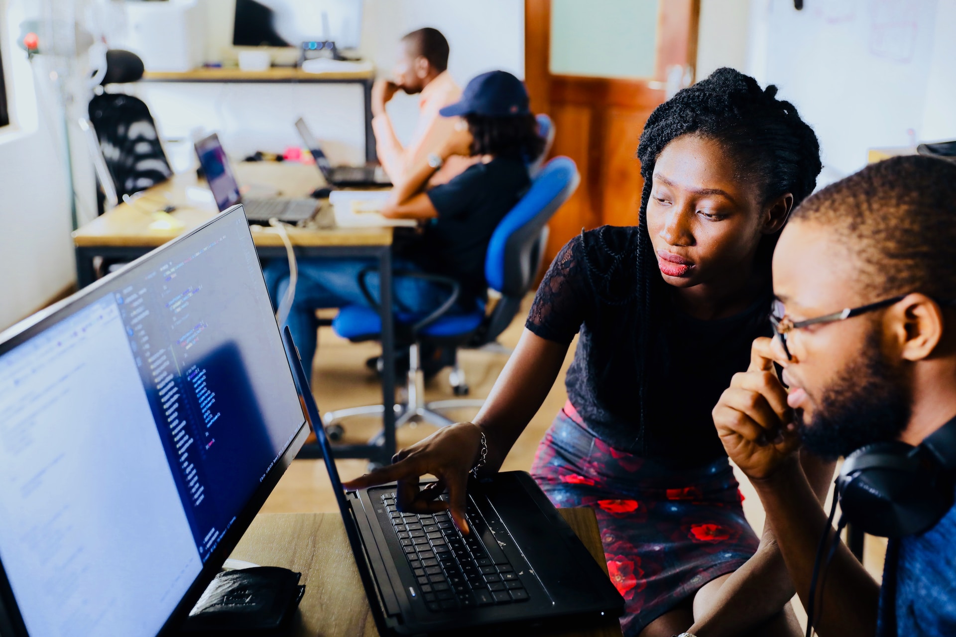 Two people using a computer.